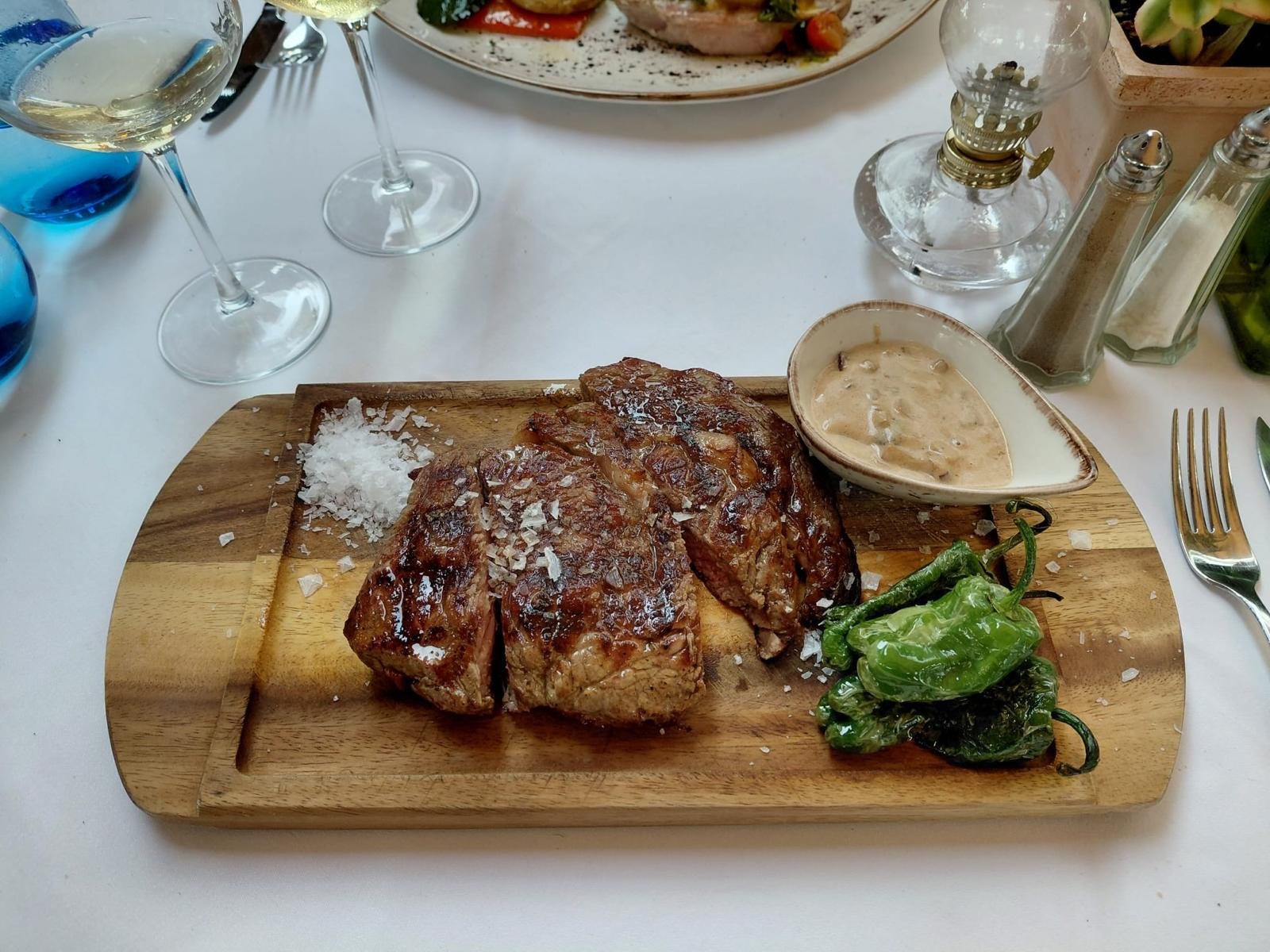 Grilled steak served with peppers and sauce at Chez Philippe